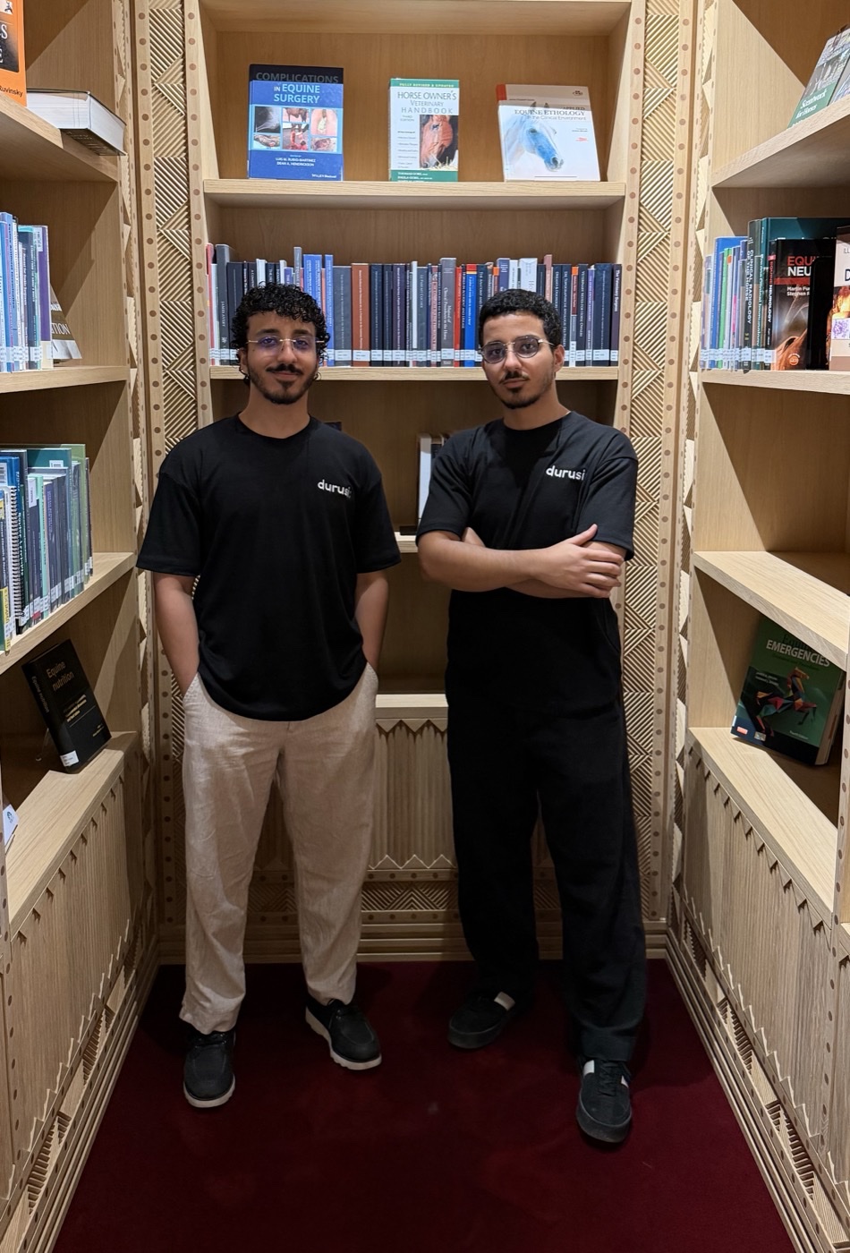 Mahmoud and Mohamed Noureldin, the twin brothers who founded Durusi, standing side by side in a library